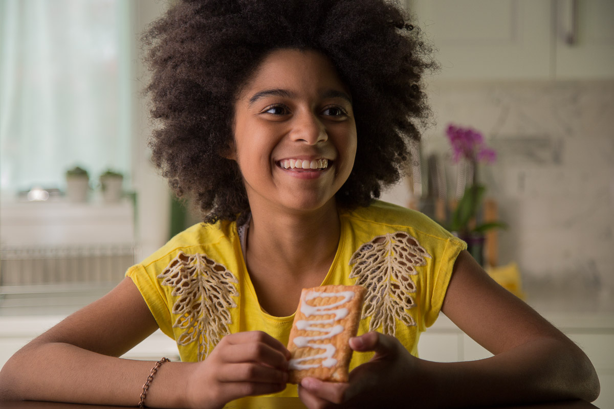 a girls shows her toaster strudel to the camera